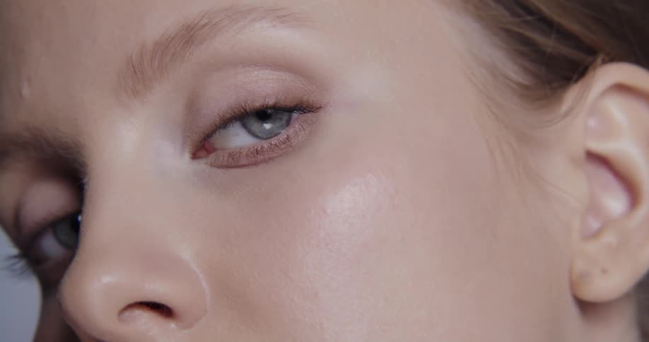 A model runs her fingers along her cheek