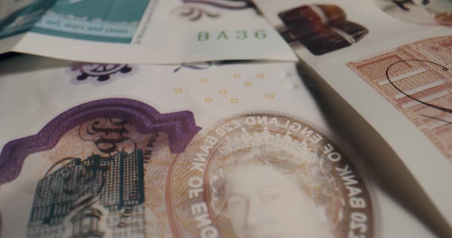 A pile of british banknotes on a flat surface