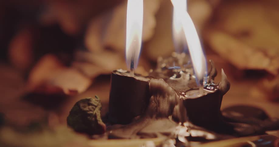 Flames burning on a melted candle