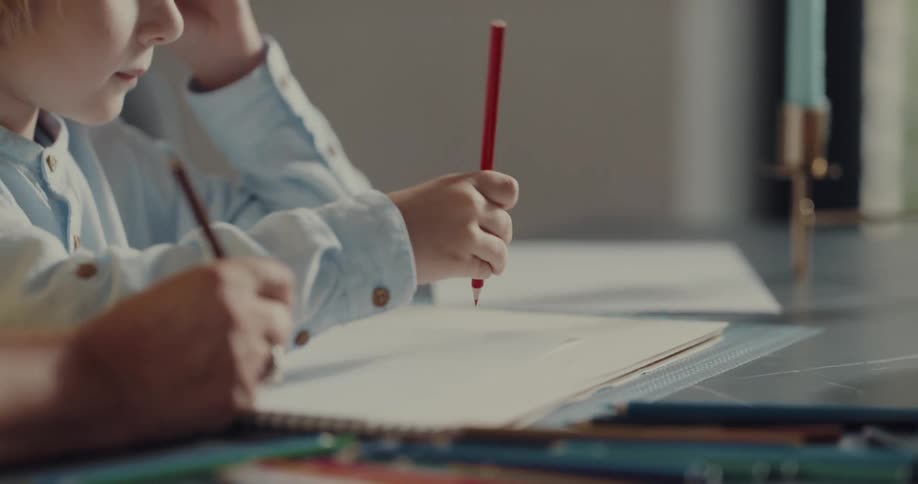 A woman and child are drawing together