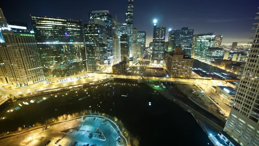 Traffic passes through city streets at night