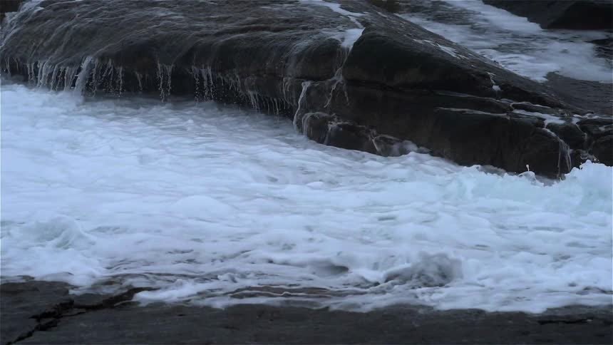 Waves crash on rocks