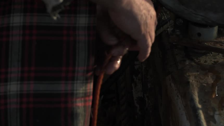 Cord is being pulled from a machine from a man
