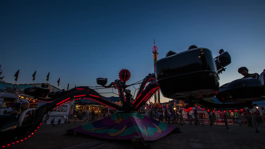 An amusement park ride during sunset