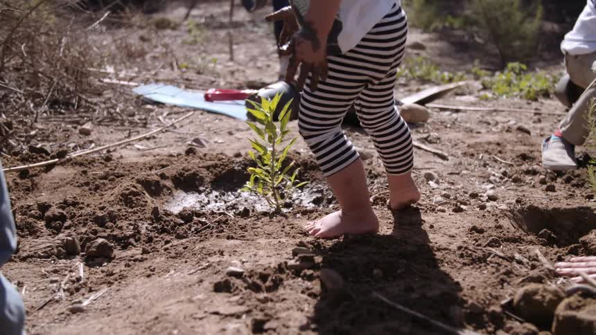 A child plays in the mud