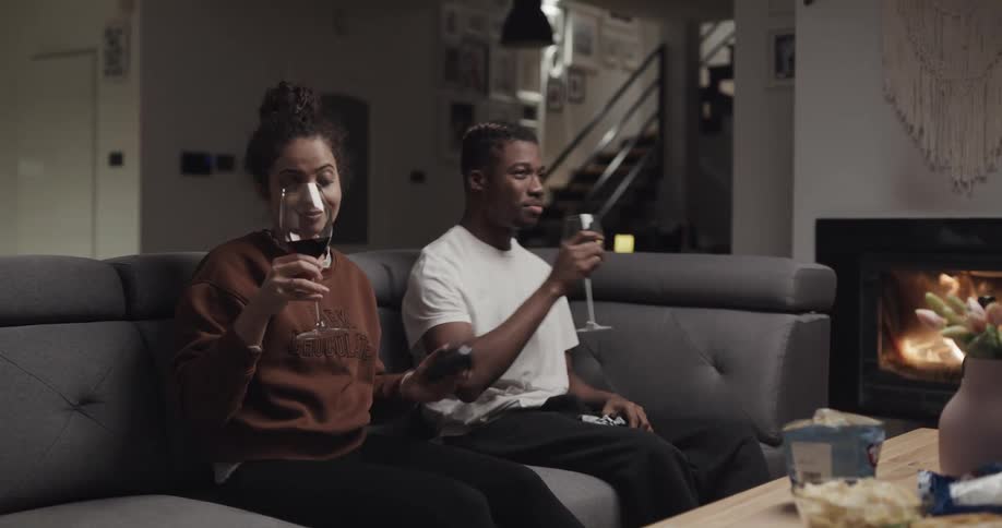 Two people are hanging out and drinking wine