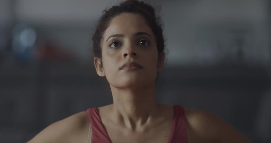 A woman practices yoga while indoors