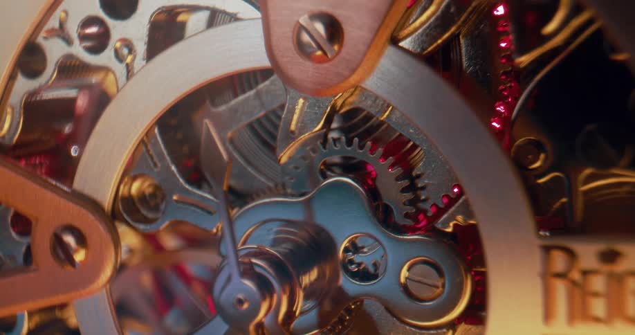 Gears and wheels inside a mechanism are turning