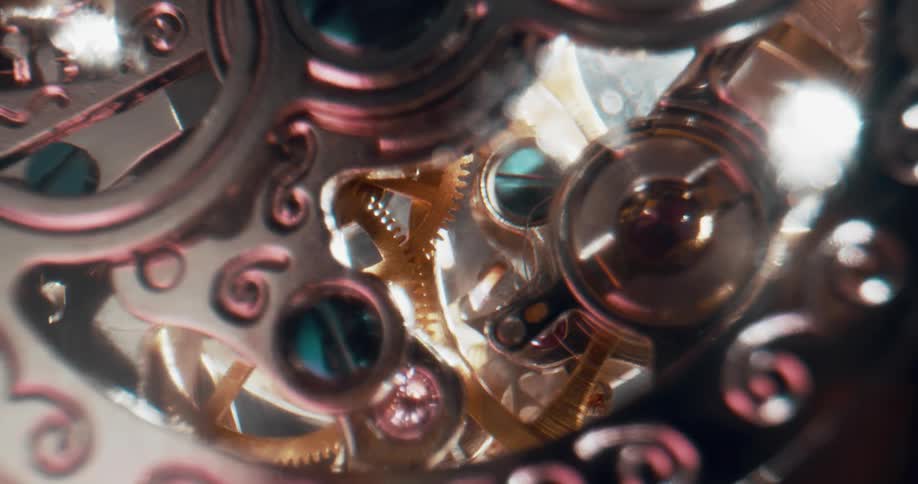 Lights flash as gears and wheels inside a mechanism turn and move