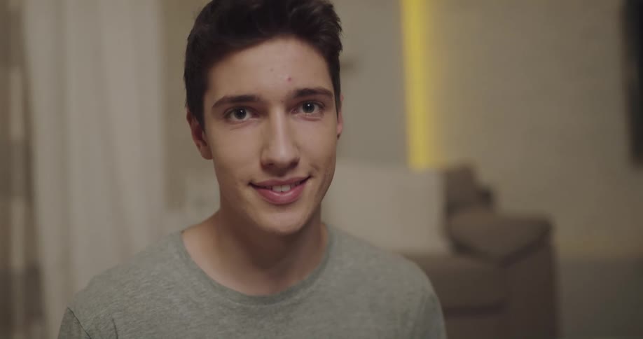 Young teenage man smiles while looking at the camera