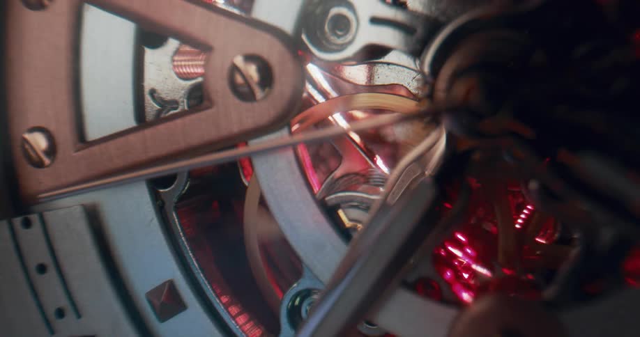 Close up of the moving gears on the functioning mechanism of an analog clock