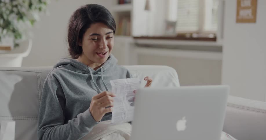 A woman talking on a laptop