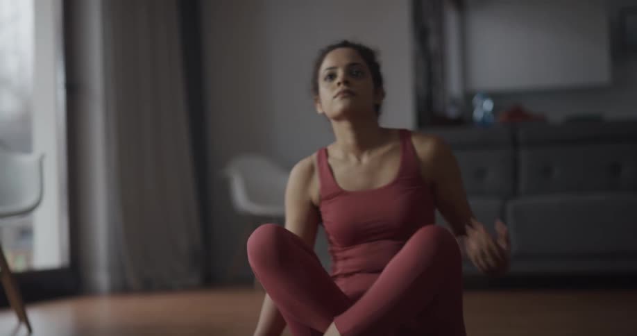 Young woman is doing yoga on a mat