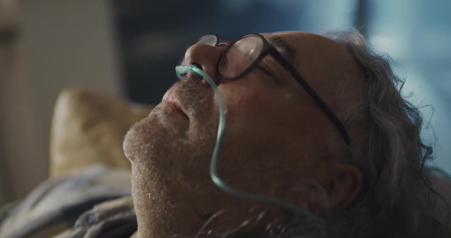 A man is resting on a couch indoors