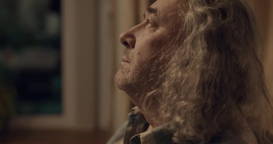 A man talks in his home
