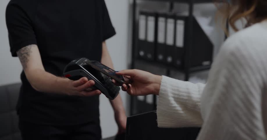 Young man is helping a woman with her phone