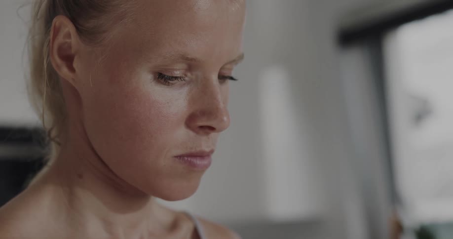 A woman is looking down at something