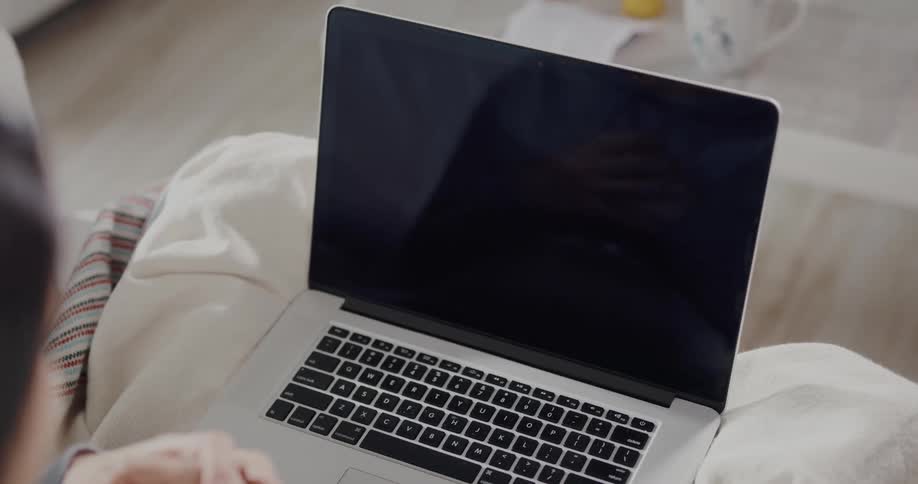 A woman talking on a laptop