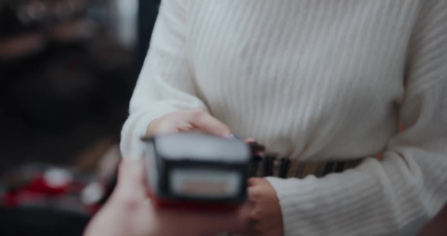 A woman pays with her cell phone