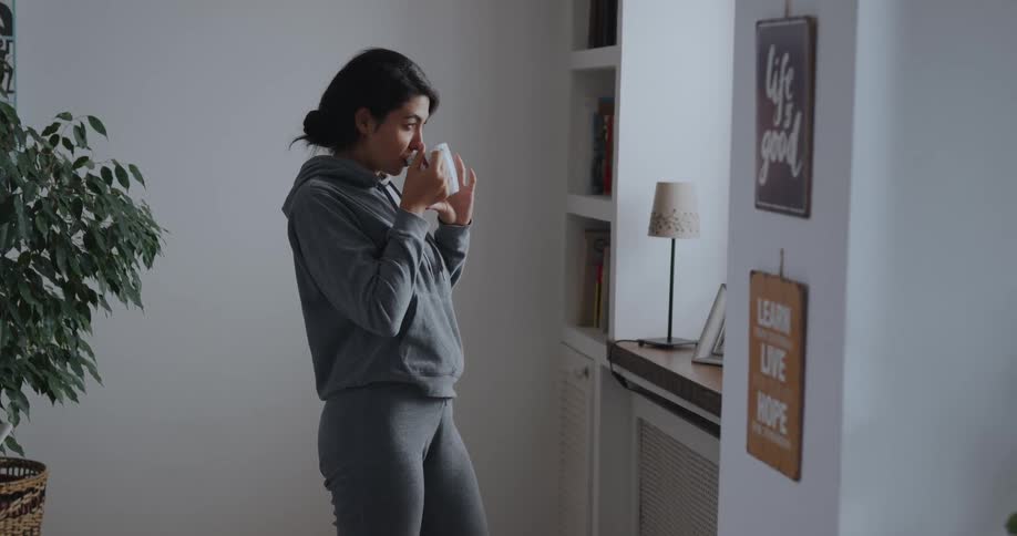 A woman drinking tea in a room