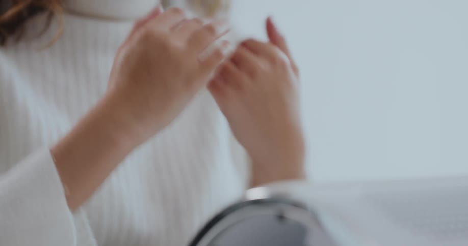 Manicurist and client rub their hands with hand sanitizer