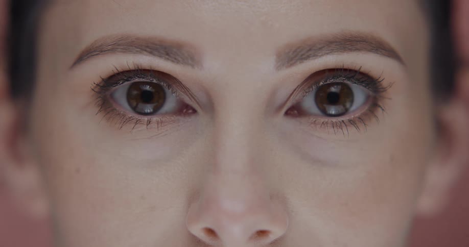 Close up of a womans eyes as she blinks and then opens her eyes