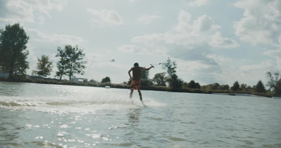 Young man water skiing in the water in the daytime