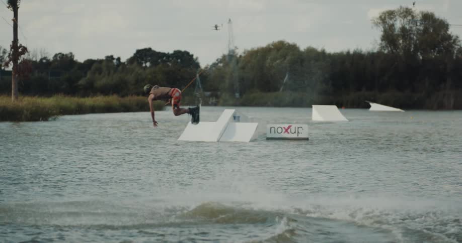 A man does a flip on the wakeboard