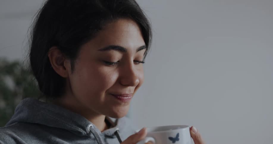 Young woman is drinking coffee