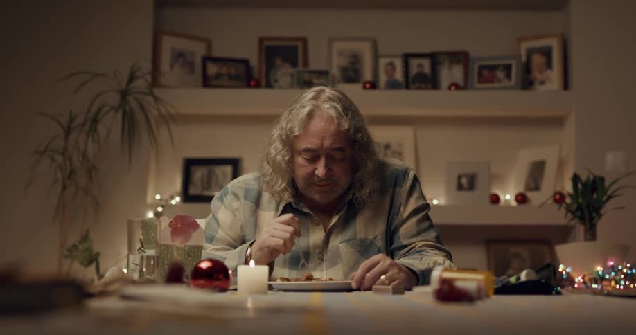A man sitting alone eating dinner