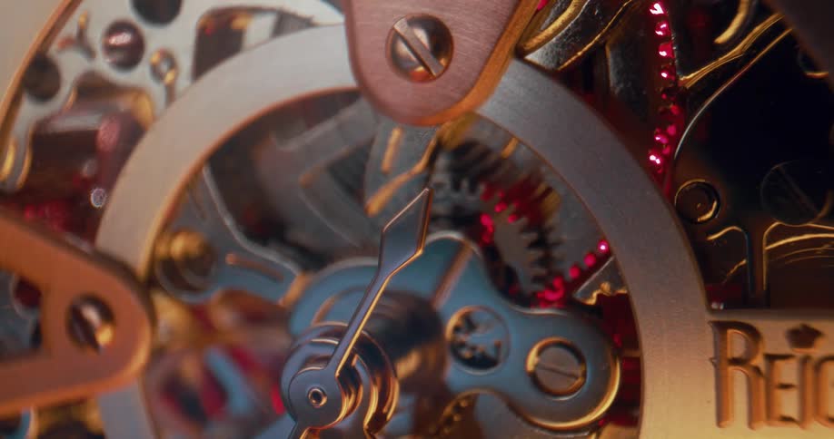 Close up of the moving gears on the functioning mechanism of an analog clock
