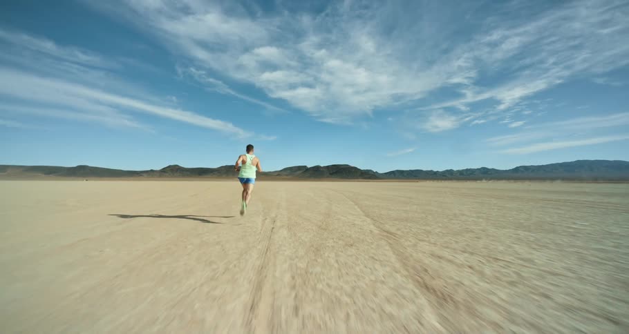 Young man is running in the desert
