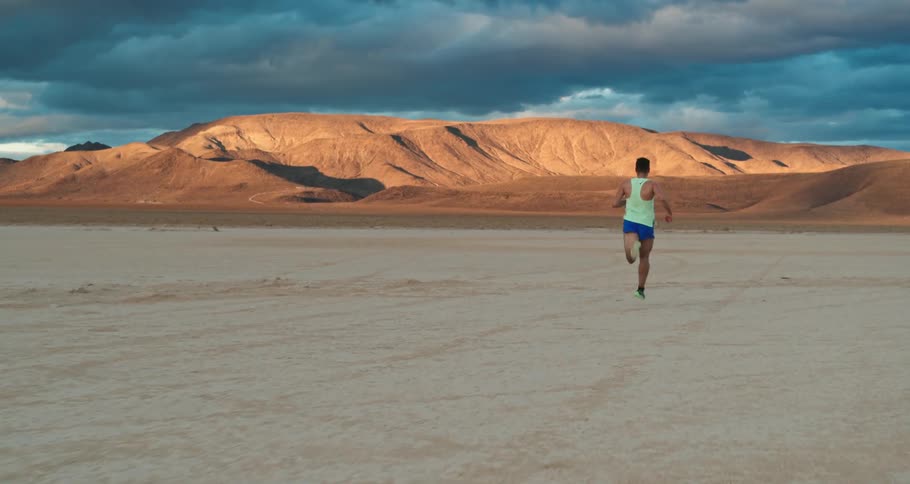 A young man running in the desert