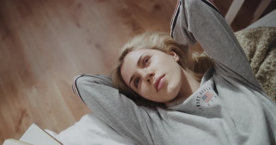 A woman is resting in bed