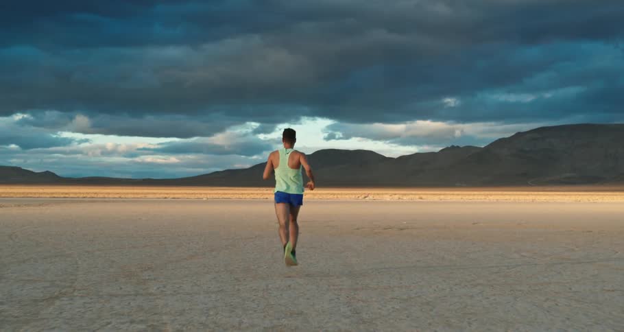 A young man running in the desert