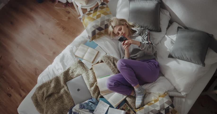 Young woman is laying on the bed
