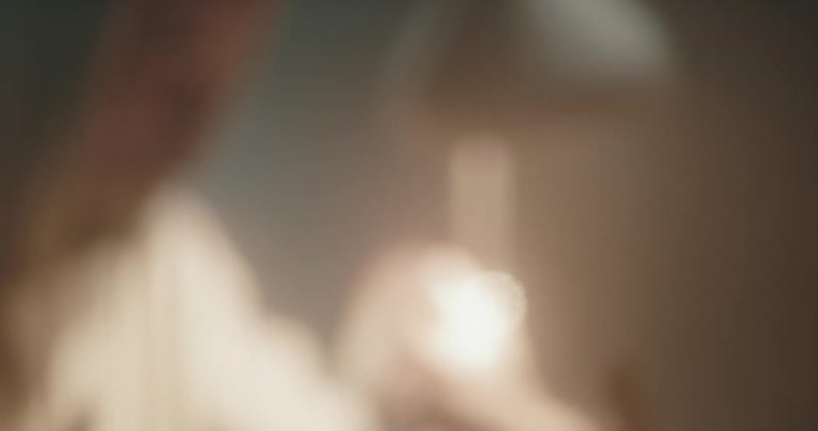 Out of focus footage of a detective talking to a suspect inside an interrogation room