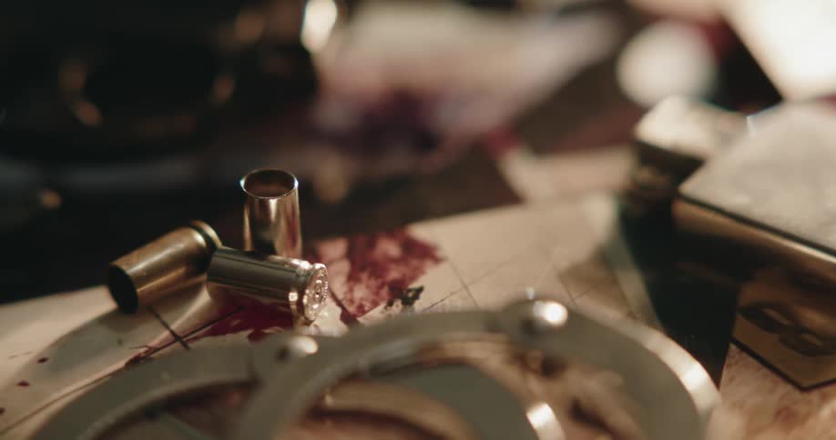 A crime scene with a gun lying by bullets and blood in a home