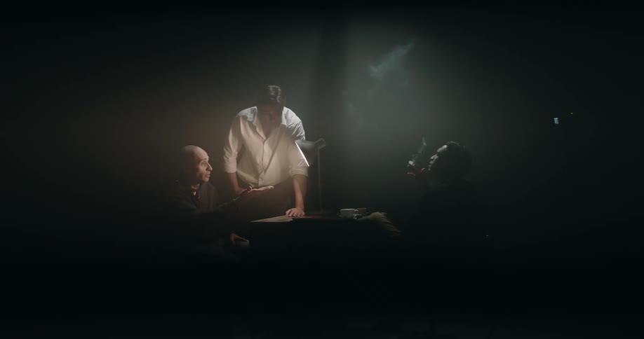 Two men interrogating a man