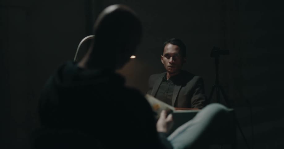 A man is smoking during an interrogation