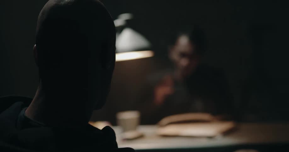 Two men are talking together in a room
