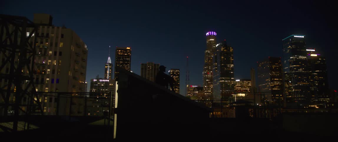 The buildings are lit at night