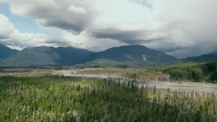 A view of a landscape with mountains is displayed at midday