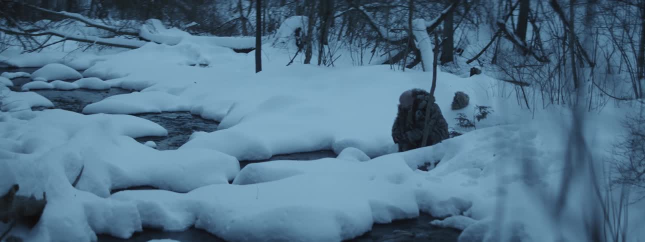Man is putting water on his face in the winter time