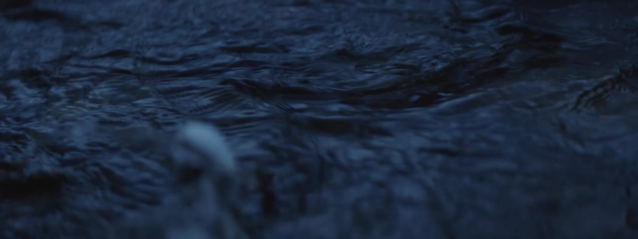 Dark water flows quickly rippling