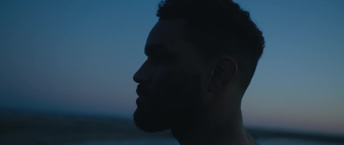 A man is standing outdoors at night