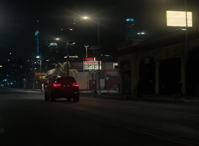 A vehicle drives through the city at night