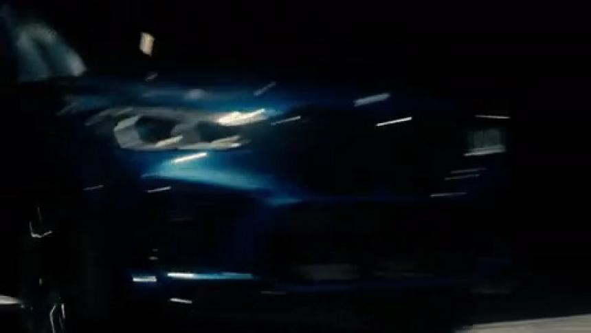 A car is driving on a street during the night