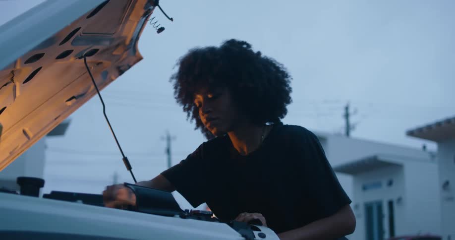 Young woman is working on a vehicle