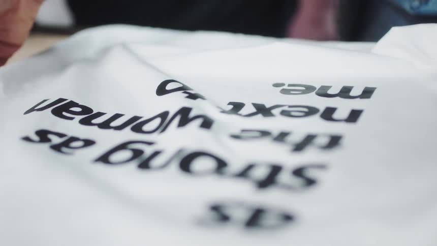 A person is checking a tshirt
